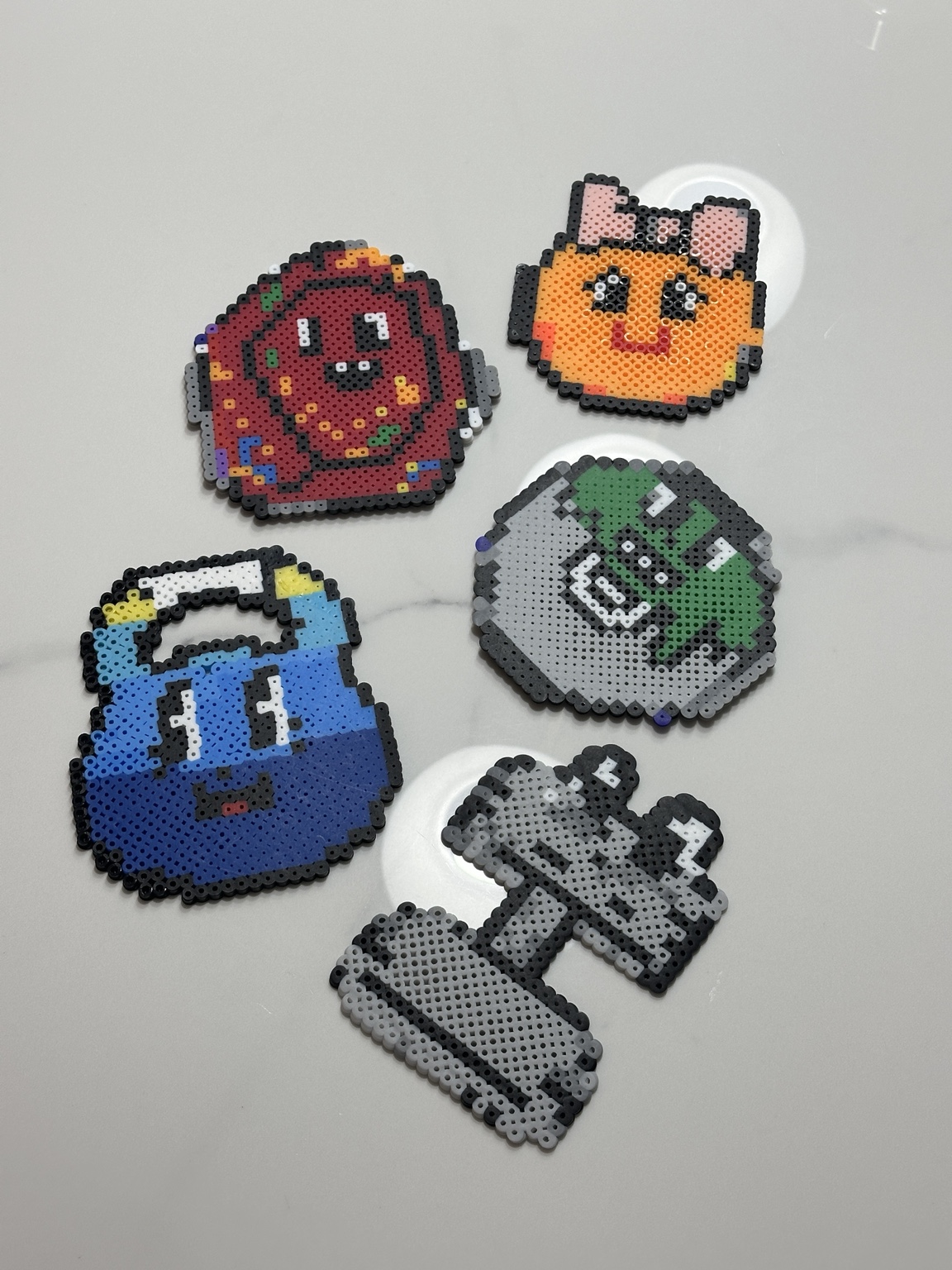 Colourful finished fuse bead designs arranged together