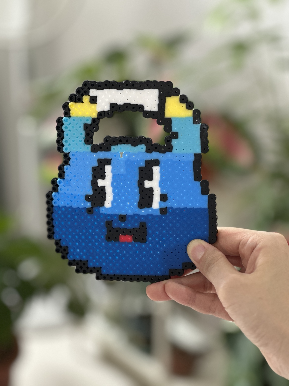 Blue smiling character made from fused beads