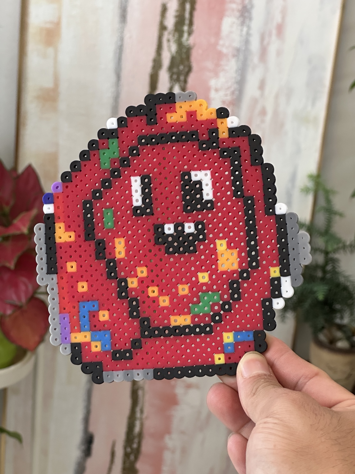 Red smiling character made from fused beads